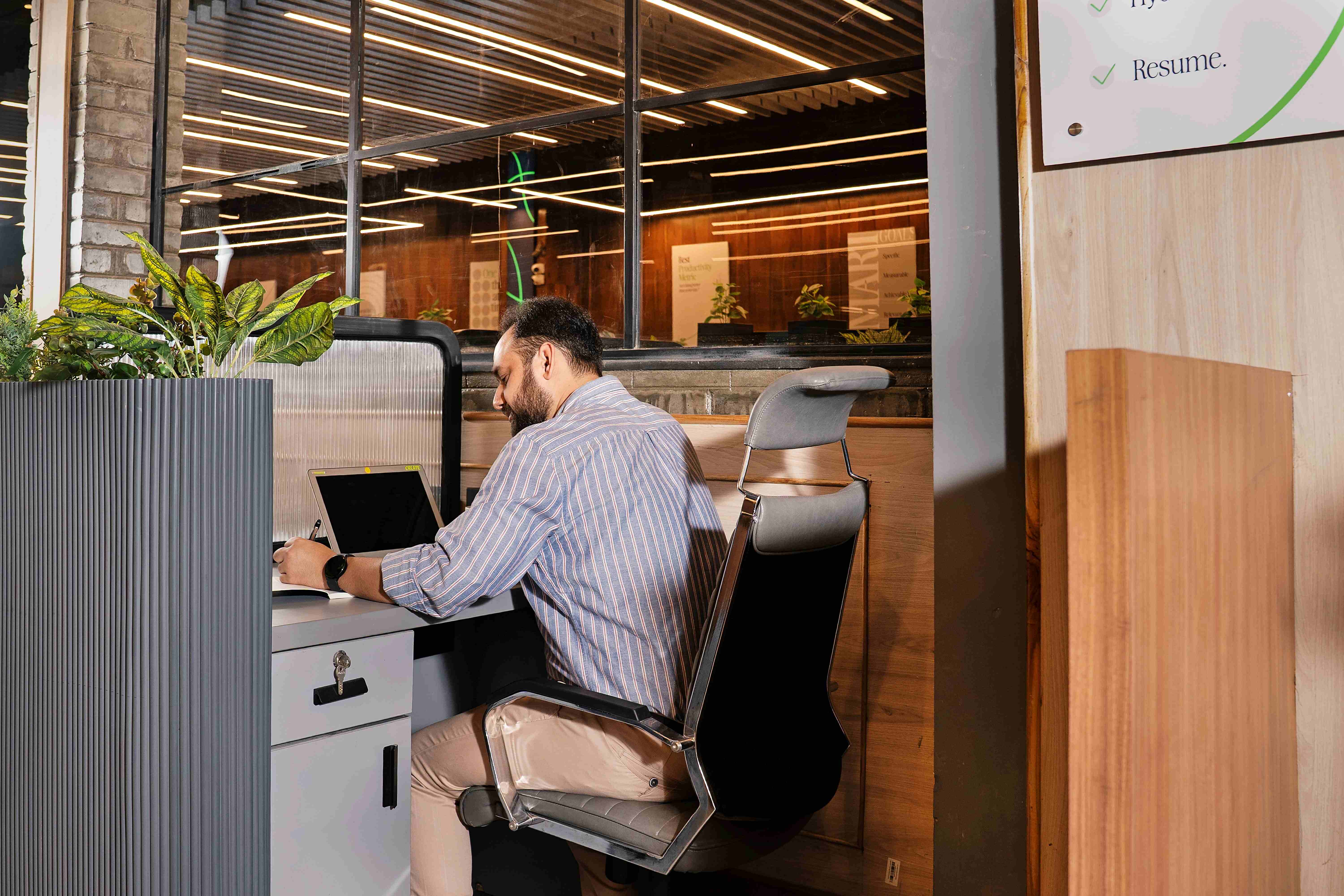 Three women sitting together at a table, working productively.